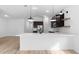 Bright, open kitchen with a large island, stainless steel appliances, and modern pendant lighting at 23411 W Albeniz Pl, Buckeye, AZ 85326