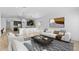 Bright living room with modern decor and an open-concept design to the kitchen at 23411 W Albeniz Pl, Buckeye, AZ 85326
