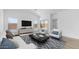 Cozy living room with stylish furniture, a contemporary entertainment center, and ample natural light at 23411 W Albeniz Pl, Buckeye, AZ 85326