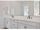Bright bathroom featuring a double vanity with quartz countertops and modern fixtures, providing ample space and contemporary style at 28233 N 134Th Ave Ave, Peoria, AZ 85383