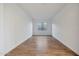 Spacious room featuring stylish wood-look flooring, bright white walls, and a window at 28233 N 134Th Ave Ave, Peoria, AZ 85383
