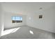Bright bedroom with plush carpet, neutral walls, and a large window offering natural light at 28233 N 134Th Ave Ave, Peoria, AZ 85383