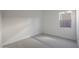Simple bedroom featuring soft carpet, white walls, trim, and a window at 28233 N 134Th Ave Ave, Peoria, AZ 85383