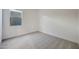Simple bedroom featuring soft carpet, white walls, trim, and a window at 28233 N 134Th Ave Ave, Peoria, AZ 85383