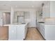 Open kitchen features an island with white countertops and stainless steel appliances at 28233 N 134Th Ave Ave, Peoria, AZ 85383