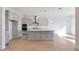 Modern kitchen with gray cabinets, an island with a breakfast bar, and stainless steel appliances at 28233 N 134Th Ave Ave, Peoria, AZ 85383