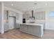 Well-lit kitchen featuring an island with seating, pendant lights, and stainless steel appliances at 28233 N 134Th Ave Ave, Peoria, AZ 85383