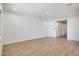 Spacious living room with wood-look tile flooring, white walls, and recessed lighting at 28233 N 134Th Ave Ave, Peoria, AZ 85383