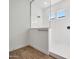 Modern glass enclosed shower with sleek white tile, offering a luxurious and bright bathing experience at 28233 N 134Th Ave Ave, Peoria, AZ 85383