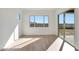 Bright sunroom featuring sliding glass doors with views of the backyard and wood-look flooring at 28233 N 134Th Ave Ave, Peoria, AZ 85383