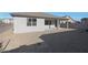 Backyard with covered patio and low-maintenance landscaping with gravel, offering a perfect space for outdoor relaxation and enjoyment at 34505 N Timberlake N Mnr, San Tan Valley, AZ 85144