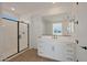 Elegant bathroom showcasing a modern vanity, a large mirror, and a glass-enclosed shower for a spa-like retreat at 34505 N Timberlake N Mnr, San Tan Valley, AZ 85144