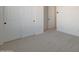 An airy bedroom with neutral walls and carpet, featuring a closet with sliding doors at 34505 N Timberlake N Mnr, San Tan Valley, AZ 85144