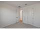 An airy bedroom with neutral walls and carpet, showcasing a spacious layout and two access doors at 34505 N Timberlake N Mnr, San Tan Valley, AZ 85144