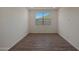 Versatile bedroom with wood-look flooring and natural light, ready to customize to your style preferences at 34505 N Timberlake N Mnr, San Tan Valley, AZ 85144