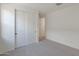 This bedroom features carpet, a closet with white sliding doors, and views to the hallway at 34505 N Timberlake N Mnr, San Tan Valley, AZ 85144
