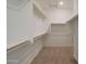 Spacious walk-in closet with custom shelving and ample storage space for organization and convenience at 34505 N Timberlake N Mnr, San Tan Valley, AZ 85144