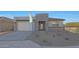 A modern single-story home featuring neutral colors, low maintenance landscaping, and an attached two car garage at 34505 N Timberlake N Mnr, San Tan Valley, AZ 85144