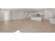 Open-concept great room, featuring a kitchen with white cabinets, a large island, and modern appliances at 34505 N Timberlake N Mnr, San Tan Valley, AZ 85144