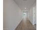 Bright hallway with wood-look flooring leading towards a sunlit room, providing an open and inviting transition space at 34505 N Timberlake N Mnr, San Tan Valley, AZ 85144