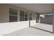 Spacious covered patio features concrete flooring, multiple windows and sliding glass door for convenient indoor-outdoor living at 34505 N Timberlake N Mnr, San Tan Valley, AZ 85144