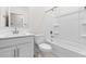 Bright, all-white bathroom featuring a tub, shower, and modern vanity at 7504 S 75Th Dr, Laveen, AZ 85339