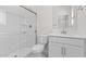 Modern bathroom with glass-enclosed shower, vanity with storage, and sleek fixtures at 7504 S 75Th Dr, Laveen, AZ 85339
