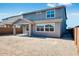 Exterior view of a two-story home featuring a covered patio and a spacious dirt backyard at 8975 S 168Th Ln, Goodyear, AZ 85338