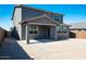 Back view of a two-story home featuring a covered patio and spacious backyard space at 8975 S 168Th Ln, Goodyear, AZ 85338