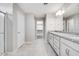 Bathroom with granite counters, double sinks, and walk-in shower; neutral color palette and spacious layout at 8975 S 168Th Ln, Goodyear, AZ 85338