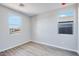 Empty bedroom with hardwood flooring and two windows at 8975 S 168Th Ln, Goodyear, AZ 85338