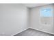 Cozy bedroom featuring soft gray carpet, neutral walls, and a window providing natural light at 8975 S 168Th Ln, Goodyear, AZ 85338