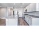 Spacious open-concept kitchen with granite counters, stainless steel appliances, and luxury vinyl flooring at 8975 S 168Th Ln, Goodyear, AZ 85338