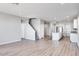 Bright open-concept living area with modern kitchen island, stainless appliances and a view of the staircase at 8975 S 168Th Ln, Goodyear, AZ 85338