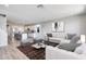 Open floor plan showcasing modern kitchen and living area with stylish, comfortable seating at 8975 S 168Th Ln, Goodyear, AZ 85338