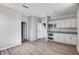 Open-concept living room with a mini-bar area, modern white cabinets, and luxury vinyl flooring at 8975 S 168Th Ln, Goodyear, AZ 85338