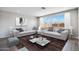 Bright living room with large windows, neutral-toned furniture, and stylish decor at 8975 S 168Th Ln, Goodyear, AZ 85338