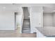 A staircase featuring carpeted steps and white banisters, leading to the upper level of the home at 8975 S 168Th Ln, Goodyear, AZ 85338