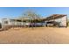 Charming blue single-story home boasting a covered porch and an adjacent carport sheltering a boat at 10120 E Mclellan Rd, Mesa, AZ 85207