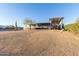 Cozy single-story home featuring a covered porch and an adjacent carport with ample space for a boat at 10120 E Mclellan Rd, Mesa, AZ 85207