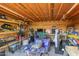 Organized garage interior featuring a variety of tools and equipment, with wood shelving and a well-lit space at 10120 E Mclellan Rd, Mesa, AZ 85207