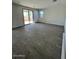 Open-concept living room with tile flooring and sliding glass doors at 23327 W Florence Ave, Buckeye, AZ 85326