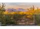 Scenic mountain views from the backyard, framed by a metal fence and desert landscaping at 34801 N 53Rd St # 26, Cave Creek, AZ 85331