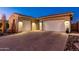 Two-car garage, Spanish style home with a brick driveway, desert landscaping at 34801 N 53Rd St # 26, Cave Creek, AZ 85331