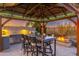 Covered outdoor kitchen with seating area and fire pit at 34801 N 53Rd St # 26, Cave Creek, AZ 85331