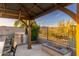 Outdoor kitchen with built-in grill, fire pit, and pergola at 34801 N 53Rd St # 26, Cave Creek, AZ 85331