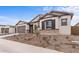 New construction home with desert landscaping and neutral colors at 37767 W Padilla St, Maricopa, AZ 85138