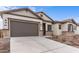 Modern home with stone accents and a two-car garage at 37767 W Padilla St, Maricopa, AZ 85138