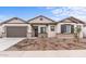 Single-story home with a brown garage door and landscaping at 37767 W Padilla St, Maricopa, AZ 85138