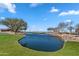 Picturesque pond with mature trees and walking paths, enhancing the community's appeal at 37767 W Padilla St, Maricopa, AZ 85138